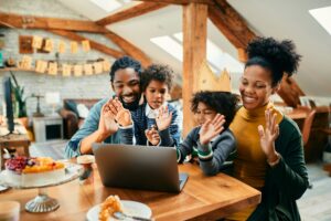 Happy black family making video call during little girl's Birthday party at home.